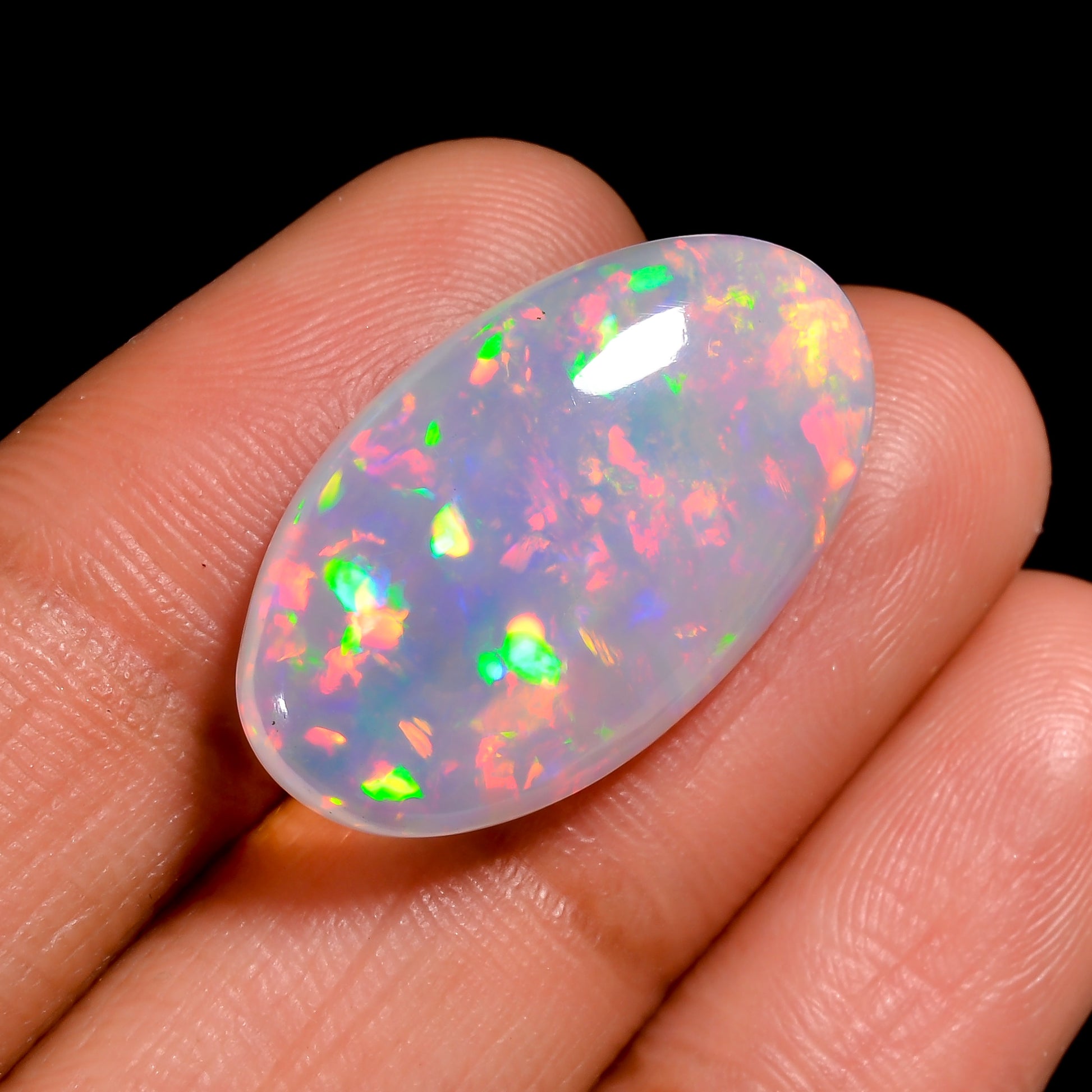 Loose 10 Ct White Ethiopian Opal stone showing vibrant fire.
