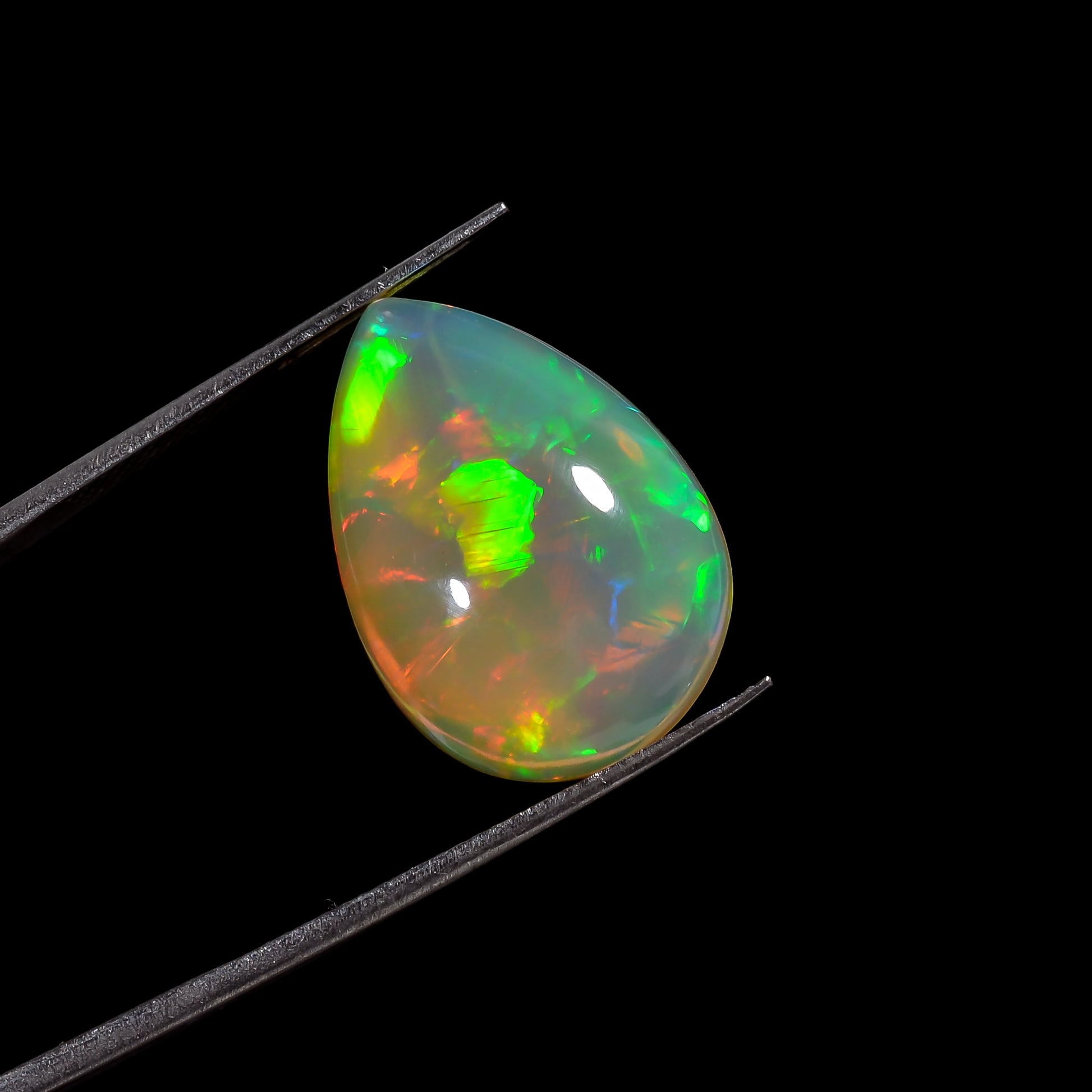 9.00 carat White Ethiopian Opal pear-shaped cabochon gemstone with colourful fire paly 
