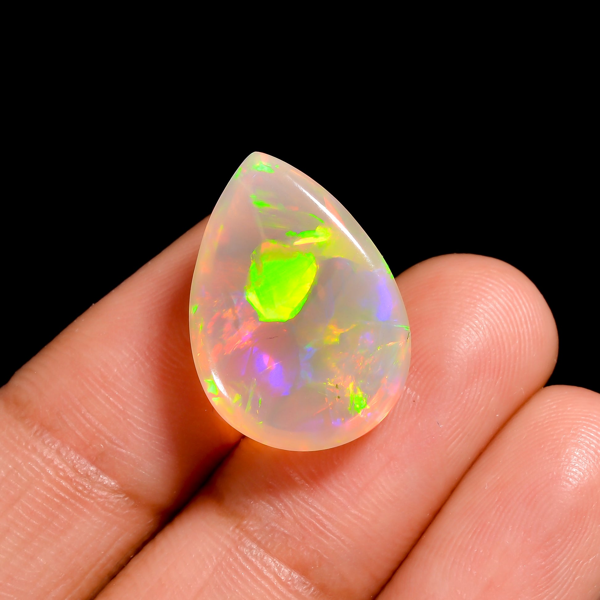 Elegant 9.00 Carat Ethiopian White Opal Cabochon pear cut gemstone with stunning color play 
