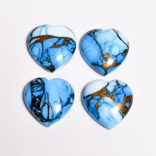 Loose blue turquoise gemstone hearts showing copper and turquoise matrix with dark webbing, top view