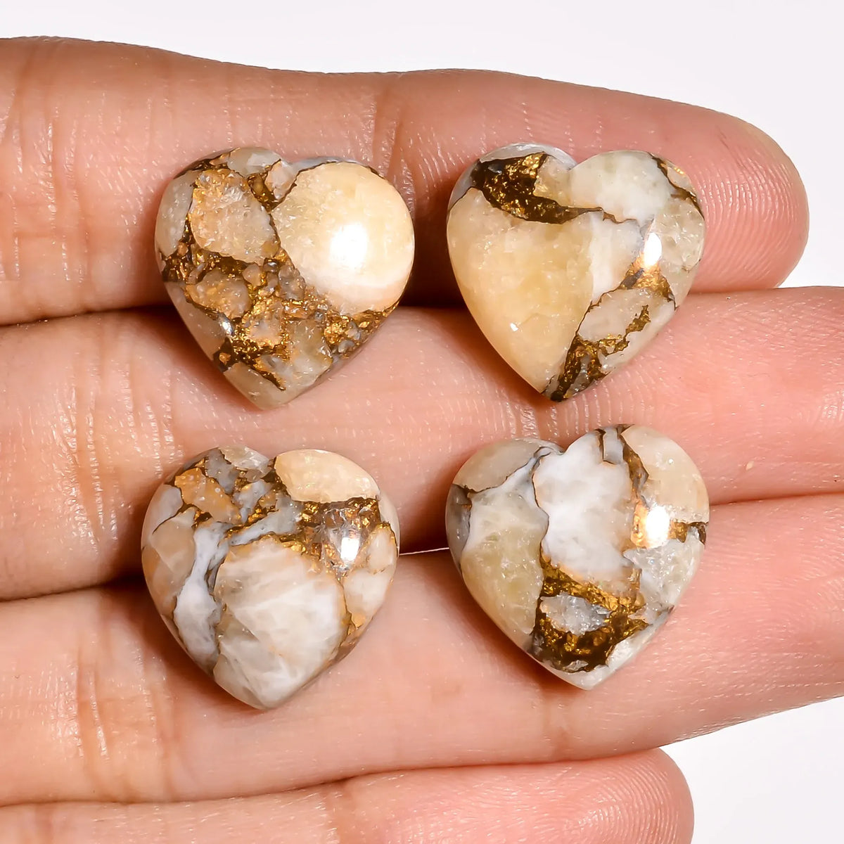 Gold copper turquoise heart stones for jewelry making held in hand to show 15 MM size