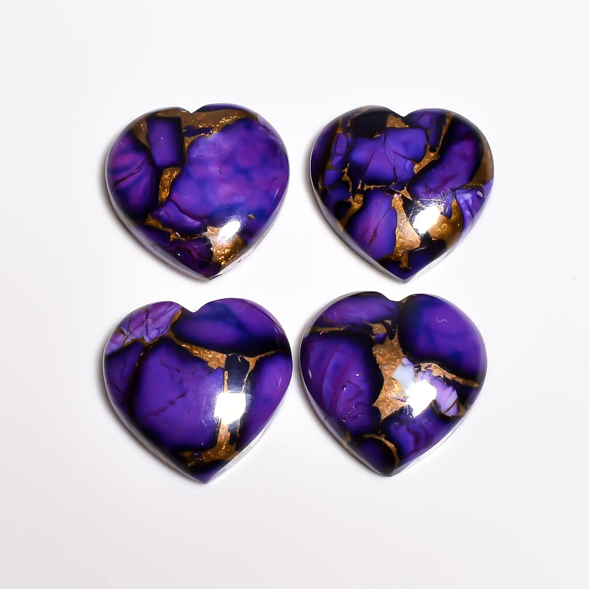 Deep violet turquoise crystal hearts, polished loose gemstones with copper and turquoise matrix, top view