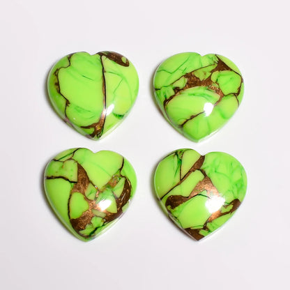 Polished green copper turquoise gemstone hearts in lime color, top-down view