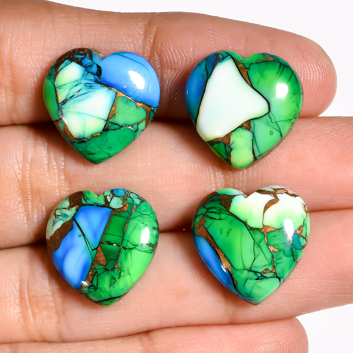 Green Turquoise heart cabochon photographed under multiple lighting angles, showing how the stone's color shifts from natural light to warm indoor light