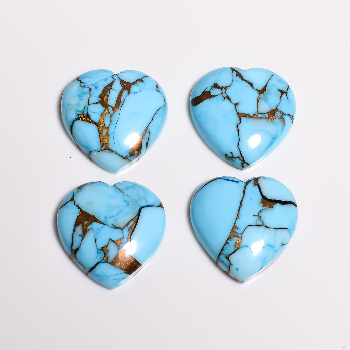 Close-up of the soft sky tone on this light blue turquoise heart, showing how light sits across the polished dome