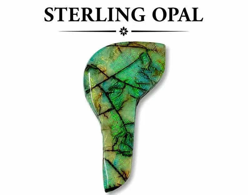 Freeform lab-created Monarch opal cabochon showing green-to-blue color shift with gold flecks and dark matrix cracking, flat back, isolated on white