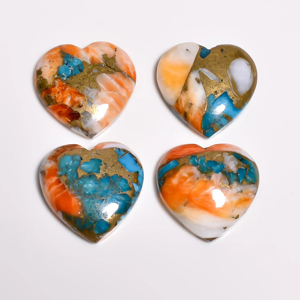Polished oyster copper turquoise gem hearts showing teal turquoise chips in copper and turquoise matrix, top view