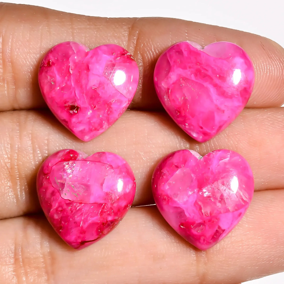 Pink turquoise gem hearts for jewelry making held on fingers to show the 15 MM size