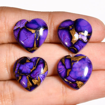 Purple turquoise gemstone hearts for jewelry making held on a hand to show 15 MM size