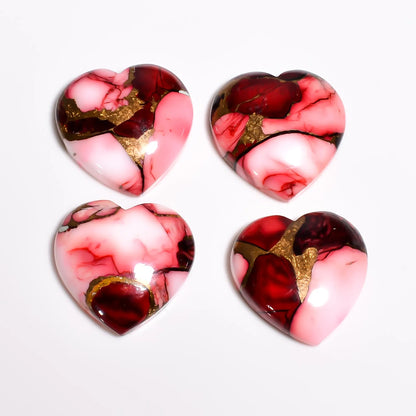 Red and pink copper turquoise gemstone hearts with glossy domed tops and gold veins, top view