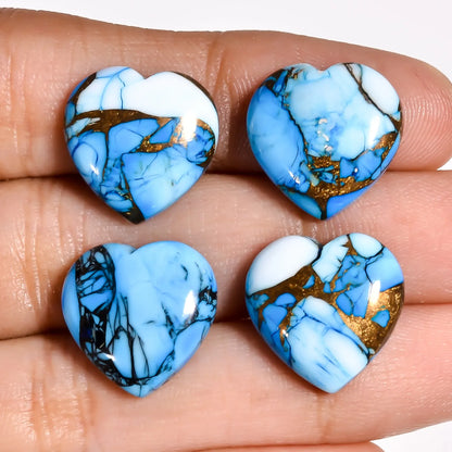 Blue turquoise gem heart cabochons for jewelry making held on a hand to show 15 MM size