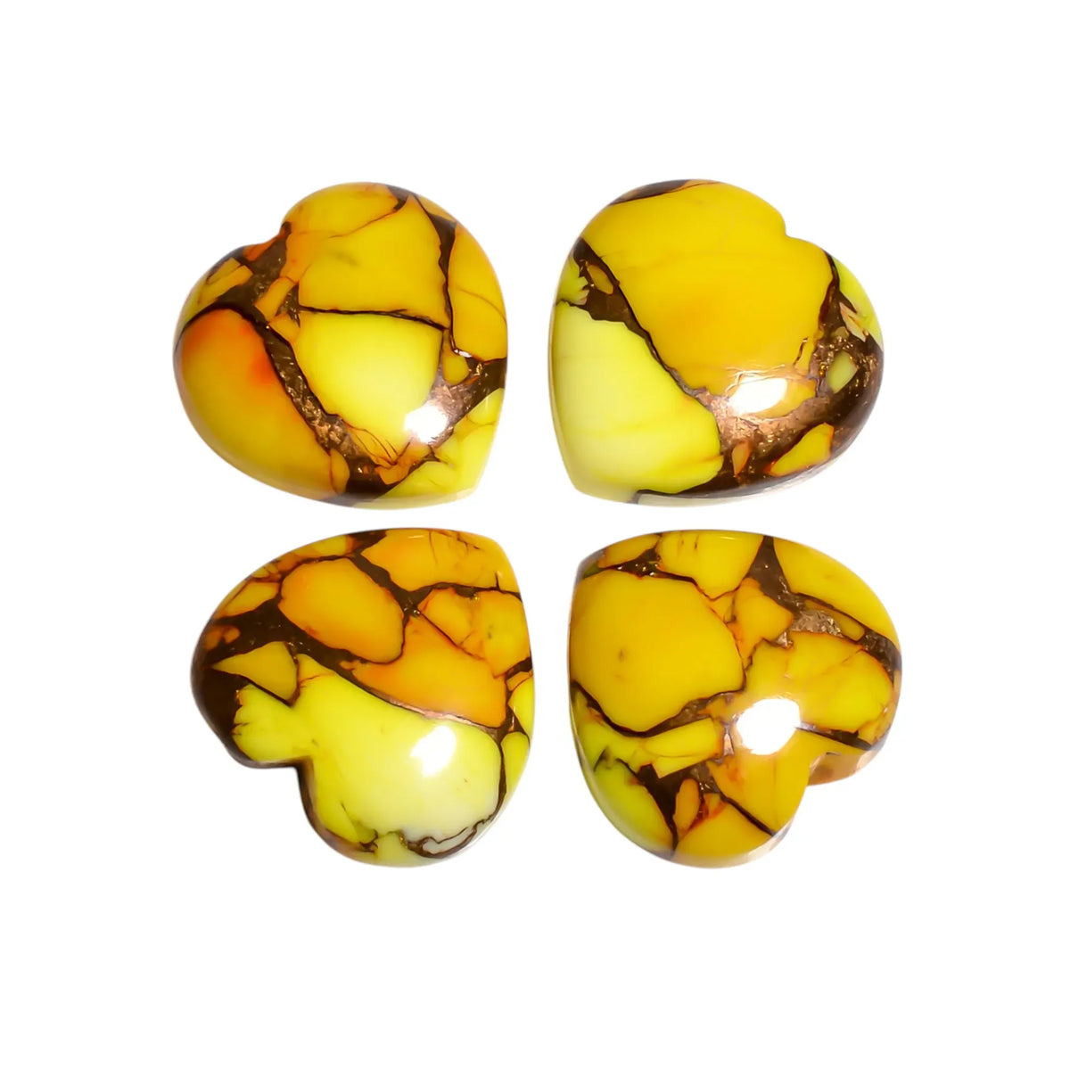 Four yellow Mohave turquoise stone hearts with lemon and orange patches and copper veins on a white background