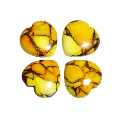 Four yellow Mohave turquoise stone hearts with lemon and orange patches and copper veins on a white background