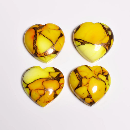 Polished yellow turquoise stone hearts, loose gemstones with glossy domed tops, top-down view